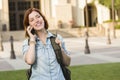 Young Female Student Walking Outside Using Cell Phone Royalty Free Stock Photo