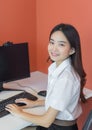 Young female students in uniform are using personal computers in the classroom in university Royalty Free Stock Photo