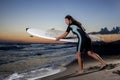 Young female surfer on beach in sunset Royalty Free Stock Photo