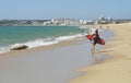Female surfer on the Armacao beach, Algarve - Portuga