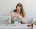 Young female tailor working on new garment at her workplace in studio Royalty Free Stock Photo