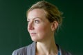 Young female teacher looking pensively aside in class