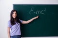 The young female teacher student in front of green board Royalty Free Stock Photo