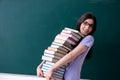 The young female teacher student in front of green board Royalty Free Stock Photo
