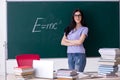 The young female teacher student in front of green board Royalty Free Stock Photo