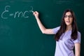 The young female teacher student in front of green board Royalty Free Stock Photo