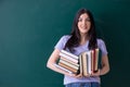 Young female teacher student in front of green board Royalty Free Stock Photo