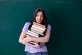 Young female teacher student in front of green board Royalty Free Stock Photo