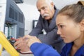 young female technician using multimeter on appliance