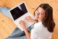 Young female teenager with laptop sitting