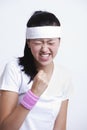 Young female tennis player celebrating success against white background