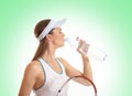A young female tennis player is drinking water Royalty Free Stock Photo