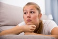 Young female is thoughtful and bored alone