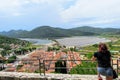 A young female tourist admiring the views of the historic medieval town of Ston, Croatia.