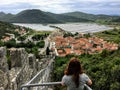 A young female tourist admiring the views of the historic medieval town of Ston, Croatia.