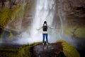 Young female tourist on the background of a waterfall Royalty Free Stock Photo