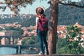 Young female tourist in a cowboy hat with sunglasses and a backpack, enjoying great view on the old town of Prague. Praha, Travel Royalty Free Stock Photo