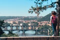 Young female tourist in a cowboy hat with sunglasses and a backpack, enjoying great view on the old town of Prague. Praha, Travel Royalty Free Stock Photo