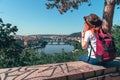 Young female tourist in a cowboy hat with sunglasses and a backpack, enjoying great view on the old town of Prague. Praha, Travel Royalty Free Stock Photo