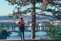 Young female tourist in a cowboy hat with sunglasses and a backpack, enjoying great view on the old town of Prague. Praha, Travel Royalty Free Stock Photo