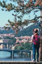 Young female tourist in a cowboy hat with sunglasses and a backpack, enjoying great view on the old town of Prague. Praha, Travel Royalty Free Stock Photo