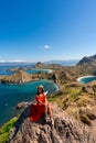 Young female tourist enjoying the beautiful landscape at Padar island in Komodo National Park