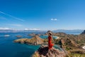 Young female tourist enjoying the beautiful landscape at Padar island in Komodo National Park