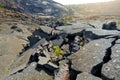 Young female tourist exploring surface of the Kilauea Iki volcano crater with crumbling lava rock in Volcanoes National Park in Bi Royalty Free Stock Photo