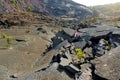 Young female tourist exploring surface of the Kilauea Iki volcano crater with crumbling lava rock in Volcanoes National Park in Bi Royalty Free Stock Photo