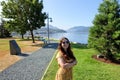 A young female tourist happy and smiling with ocean in the background, visiting the waterfront in Port Alberni, British Columbia