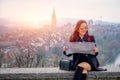 Young female tourist with map looking for a way to Beautiful view point near old town in Bern, Switzerland Royalty Free Stock Photo