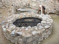 Young female tourist and stone well