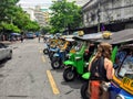 young female tourist is talking with a auto rickshaw driver.