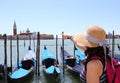 Young female tourist in Venice and gondolas