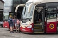 Young female tourists boarding a bus in Fionnphort Isle off Mull, Scotland, UK