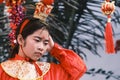 Young female in a traditional outfit and accessories for the Lantern Festival parade in Guzhen,China