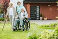 Young female trainee with elder couple in the garden