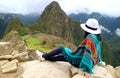 Young female traveler admiring the Inca ruins of Machu Picchu, one of the New Seven Wonder of The World, Cusco Region