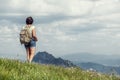Young female traveler backpacking in the mountains