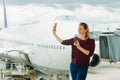 young female traveler, Blogger in airport lounge near windows happy smile taking selfie photo flight Royalty Free Stock Photo