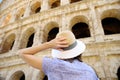 Young female traveler looking on famous the Colosseum in Rome Royalty Free Stock Photo