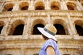 Young female traveler looking on famous the Colosseum in Rome Royalty Free Stock Photo