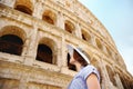 Young female traveler looking on famous the Colosseum in Rome Royalty Free Stock Photo