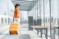 Young female traveler with a luggage at the transport stop Royalty Free Stock Photo