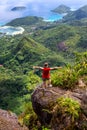 Young female traveller standing at the edge of the cliff at Morne Blanc View Point, Seychelles.