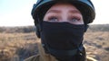Young Female Ukrainian Soldier In Military Uniform And Helmet Looks Around Her. Woman Watching At Camera With Hope In