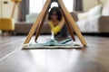 Young Female Using Mop To Clean Floor Under Chair In Living Room Royalty Free Stock Photo