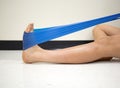 Young Female using a resistance band for ankle exercises in the gym Royalty Free Stock Photo