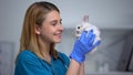 Young female vet playing with bunny, care and love to patient in animal hospital