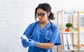 Young female veterinary doctor holding bottle of prescription pills at animal hospital Royalty Free Stock Photo